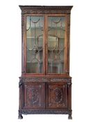A three piece 19thC. Hepplewhite style mahogany bookcase with relief decor & carved rams heads, 1070