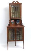 An elegant Edwardian, Sheraton Revival, two piece mahogany inlaid corner display cabinet with two ci