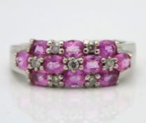 A 14ct white gold ring set with pink sapphire & se