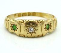 An Edwardian 18ct gold ring set with diamond & gre