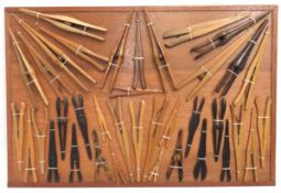A mounted collection of vintage glove stretchers