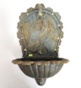 A cast iron wall fountain with tap & relief horse