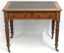 A compact Victorian leather topped walnut two draw