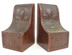 A pair of oak bookends with applied repousse coppe