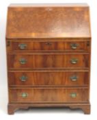 A Georgian style walnut veneer bureau with brass f