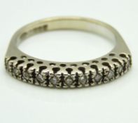 An 18ct gold ring set with eleven small diamonds o