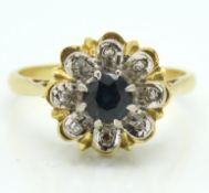 An 18ct gold ring set with sapphire & eight small