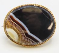A yellow metal brooch set with agate, tests electr