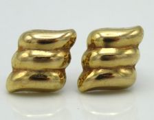 A pair of 9ct gold earrings, one gold back replace