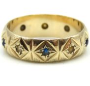 A 9ct gold band set with small blue & white stones