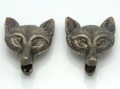 Two 1920's white metal fox collar stud buttons, 24