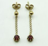 A pair of 9ct gold drop earrings set with garnet,