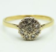 An 18ct gold daisy style ring set with nine small