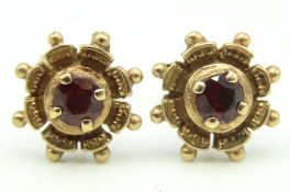 A pair of 9ct gold earrings set with garnet, 10mm
