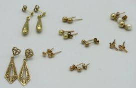 Nine pairs of 9ct gold & yellow metal earrings twinned with one odd, 3.6g