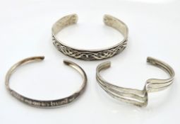 Three silver & white metal bangles including unise