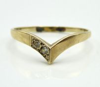 A 9ct gold wishbone ring set with two white paste