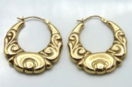 A pair of 9ct gold hoop earrings of decorative for