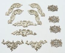 Four sets of hallmarked silver appliques made by C