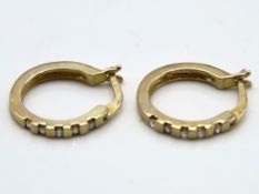 A pair of 9ct gold hoop earrings, each set with fi