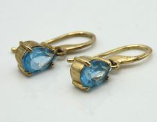 A pair of 9ct gold earrings set with topaz, 10mm d