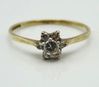 A 9ct gold ring set with floral arrangement of whi