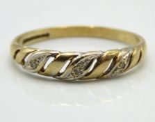A 9ct gold ring of wave form set with three small