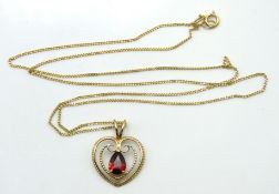 A 9ct gold chain with heart shaped garnet set pend