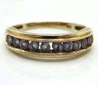 A 9ct gold half eternity ring set with amethyst, 1
