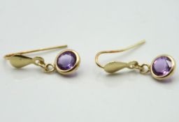 A 9ct gold pair of earrings set with amethyst, 15m