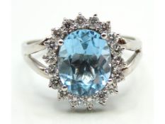 A white metal ring set with blue topaz & approx. 0