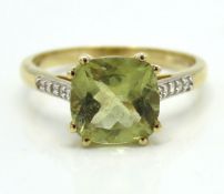 A 10ct gold ring set with possibly peridot & white