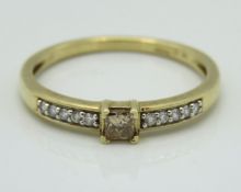 A 10ct gold ring set with champagne & white diamon