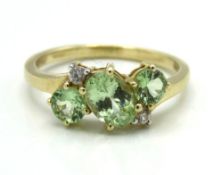A 10ct gold ring set with peridot & white topaz, 2