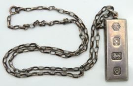 A silver ingot & chain, ingot 40mm x 15mm, chain 5
