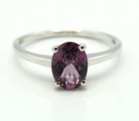A 10ct white gold ring set with possibly, purple M