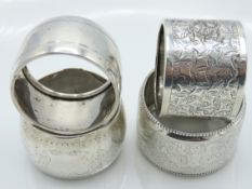 Two foreign silver napkin rings twinned with two w