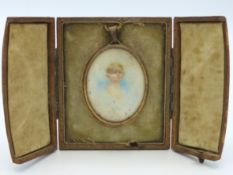 A mounted 19thC. miniature watercolour of young gi