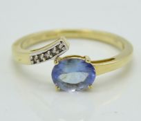 A 10ct gold tanzanite & white topaz cross over rin