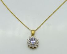 A 9ct gold chain & pendant set with tanzanite & 0.