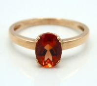 A 10ct rose gold ring set with possibly spessartit