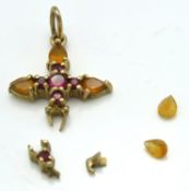 A 9ct gold cross pendant set with citrine & garnet