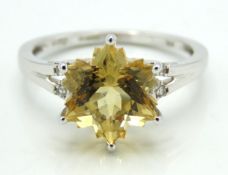 A 10ct white gold ring set with citrine & white to