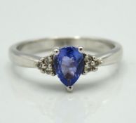 A sterling silver ring set with tanzanite & white