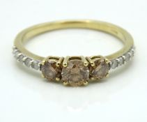 A 9ct gold ring set with champagne & white diamond