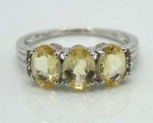 A 10ct white gold ring set with lemon citrine & wh