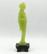 An Oriental carved jade figure, indistinctly signe