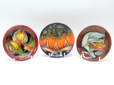 A Moorcroft pottery trio of pin dishes: 