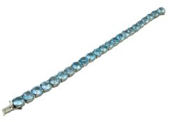 A silver mounted topaz line bracelet, stones 8mm d