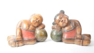 A PAIR OF VINTAGE 20TH-CENTURY CHINESE WOODEN RECLINING FIGURES